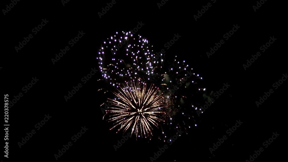Beautiful fireworks balls are located in the dark sky. Interesting drawings create three colored balls of different colors. In the center is a small ball, around it there is a large ball that forms a Beautiful fireworks balls are located in the dark sky. Interesting drawings create three colored balls of different colors. In the center is a small ball, around it there is a large ball that forms a