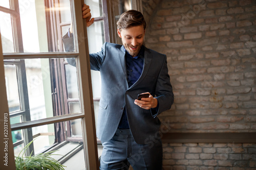 Businessperson with cell phone calling his fellow