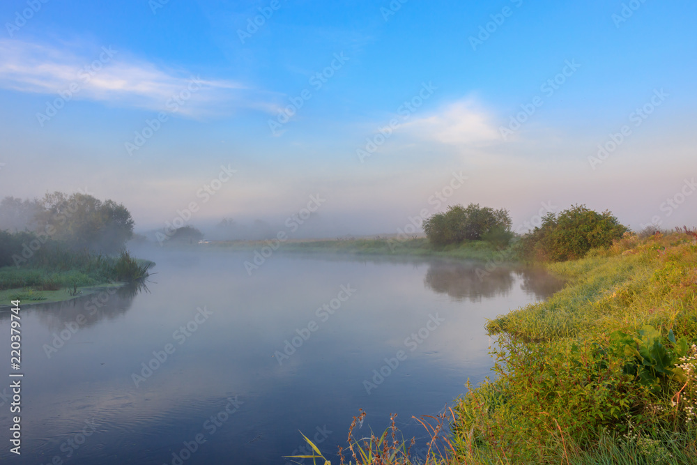 Obraz premium River with fog above surface. River landscape at sunny summer morning