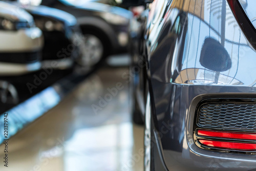 New cars at dealer showroom blurred background © Yakov