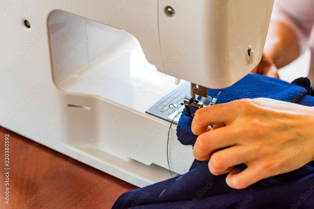 Dressmaker or seamstress works using sewing machine