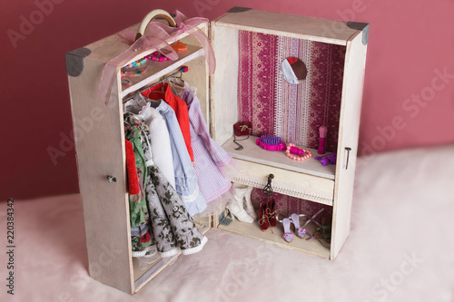 A large white chest in which the wardrobe of the doll is placed.