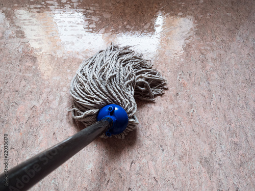 cleaning floor by rope mop photo