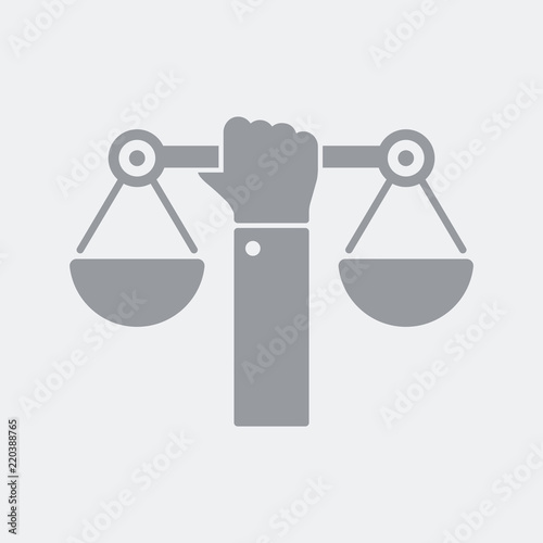 Hand holding a balance symbol of justice