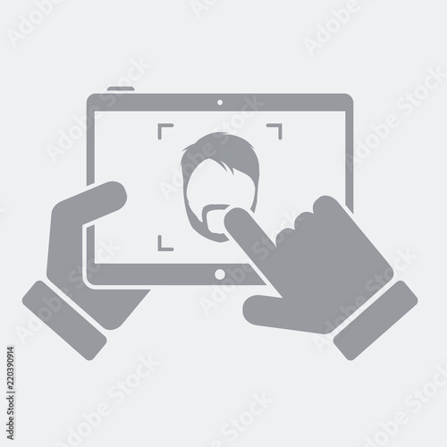 Tablet take a photo to a bearded guy