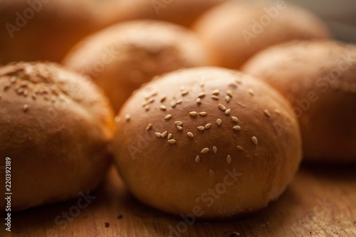 background of homemade buns with sesame seeds for hamburgers. made at home bread. natural product.