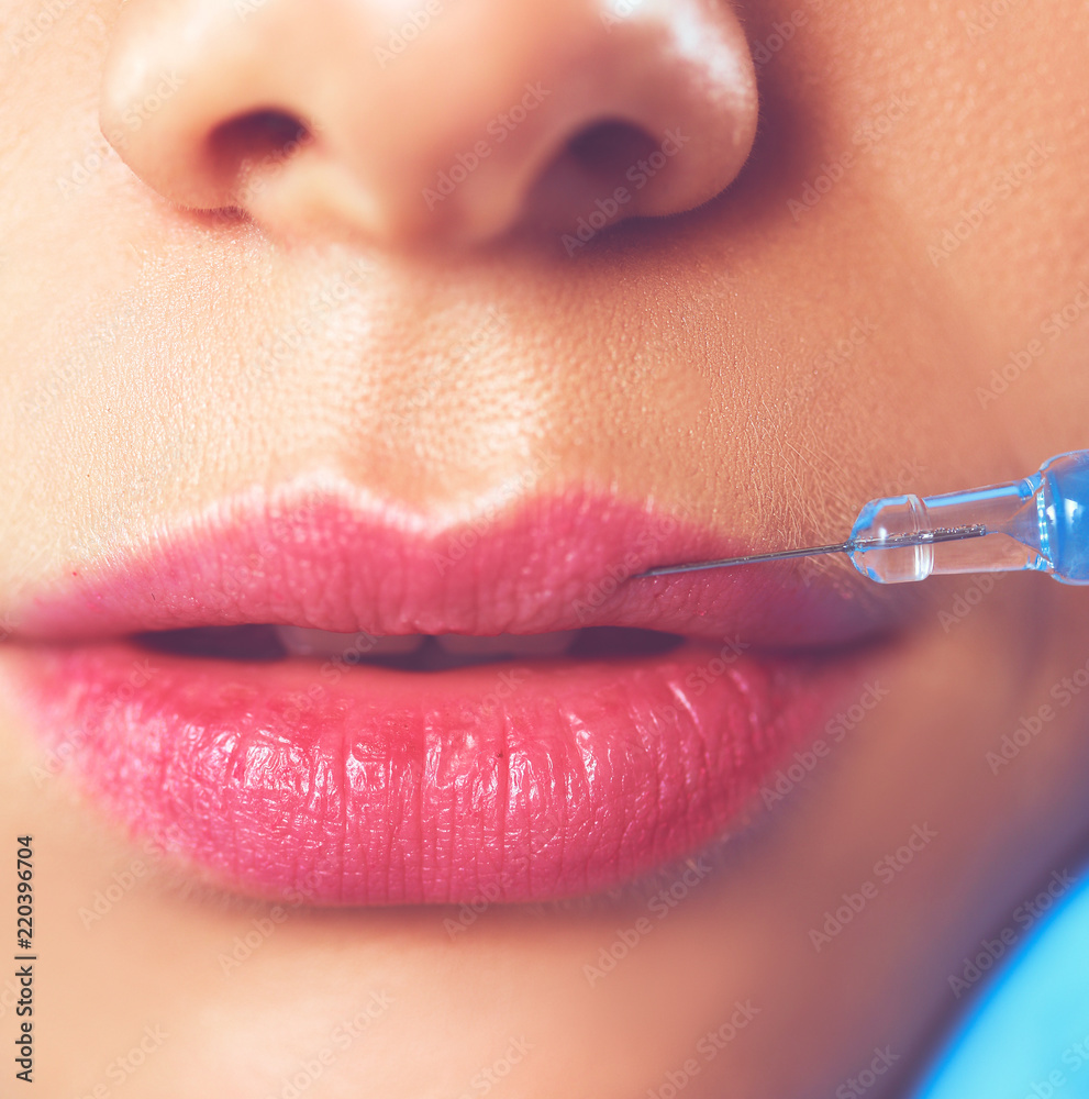Obraz premium Cosmetic injection on the pretty woman face. Isolated on gray background