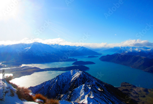 Lake Wanaka in New Zealand and surrounding mountains from the top of Roys Peak on a clear, winter day.