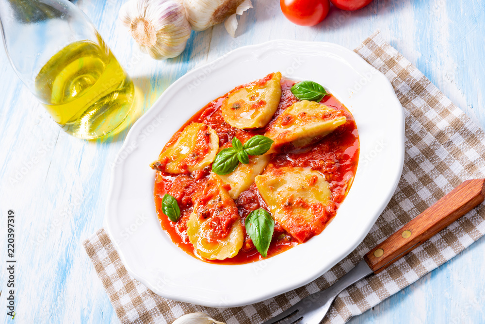 Delicious pasta - ravioli in tomato sauce with basil Delicious pasta - ravioli in tomato sauce with basil