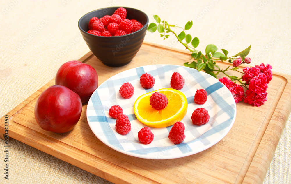 Photo of raspberries with orange,nectarine and roses. Photo of raspberries with orange,nectarine and roses.