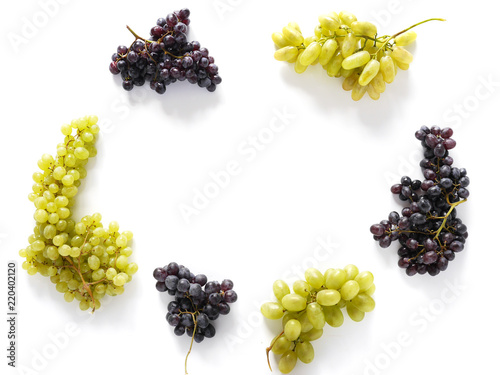 Frame of black and green grapes isolated on a white background. The pattern of grapes of different varieties, top view. Food background.