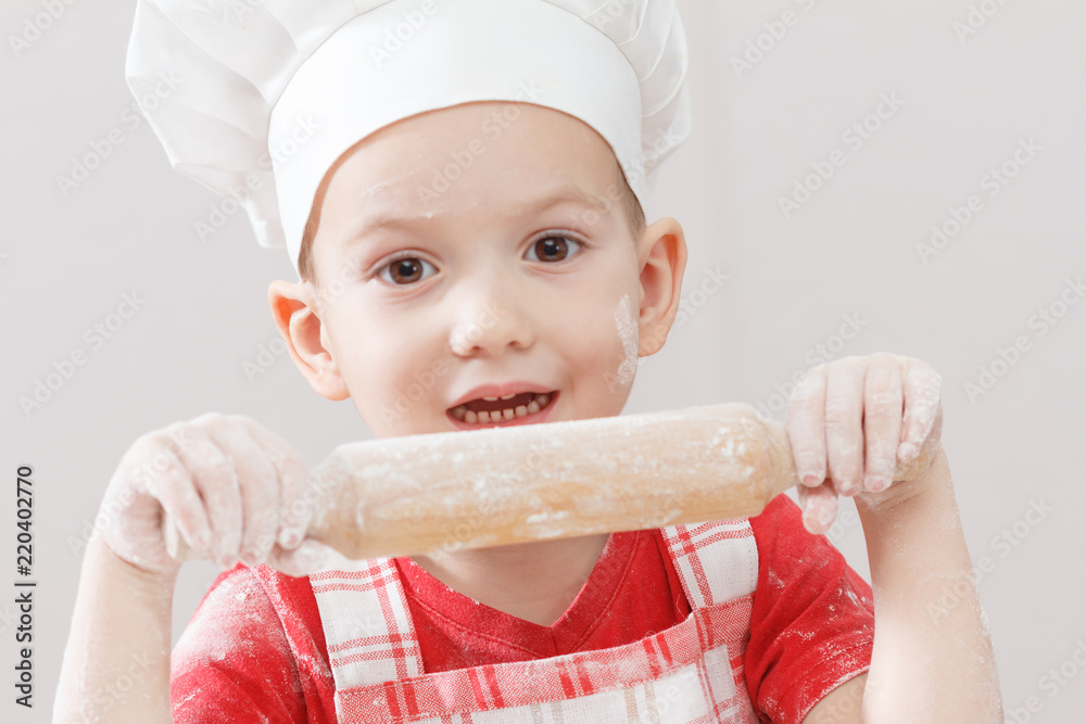 Little child making pizza or pasta dough Little child making pizza or pasta dough