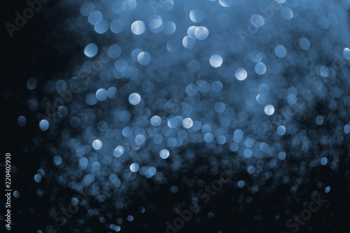abstract background with blurred glowing blue glitter