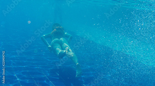 Photo of girl swims in the pool.