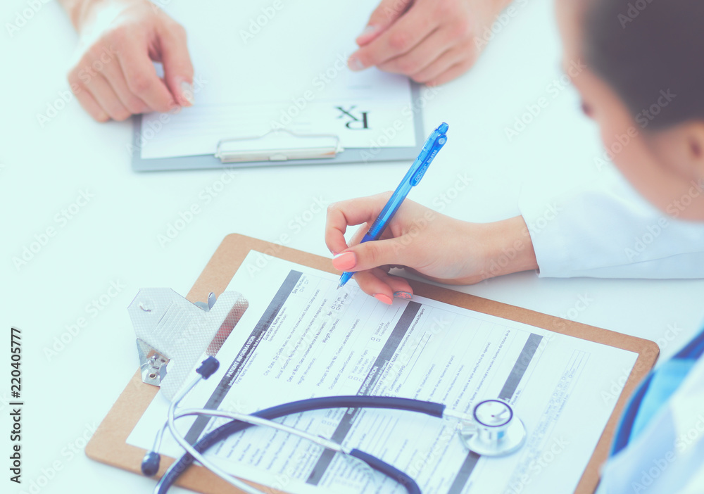 Portrait of young female doctor sitting at desk in hospital Portrait of young female doctor sitting at desk in hospital