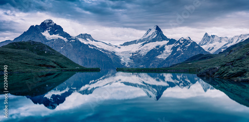 Dramamtic summer evening on Bachalpsee lake with Schreckhorn and Wetterhorn peaks on background. © Andrew Mayovskyy
