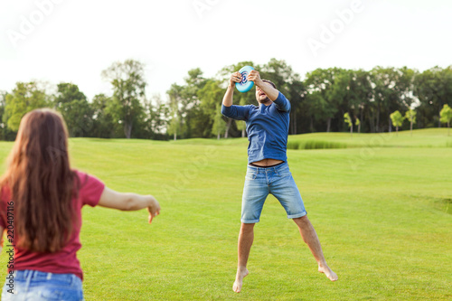 couple in love playing frisbee in the park, the concept of a healthy lifestyle.