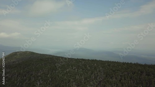 Aerial footage of White Cap Mountain situated within the watershed of the Pleasant River located in Piscataquis County, Maine. It has a distinguished treeline and remains snow covered into summer. photo