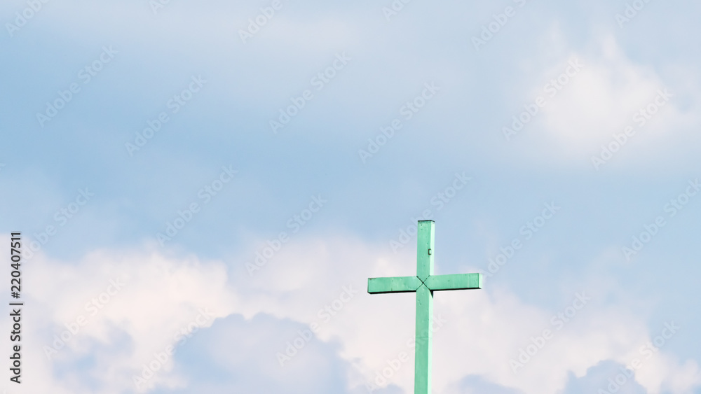 the holy cross in front of the blue sky