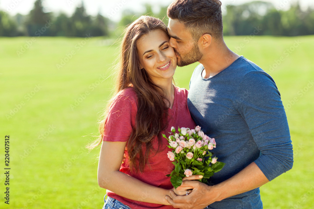 couple in love hugging in the park, concept of Valentine's Day couple in love hugging in the park, concept of Valentine's Day
