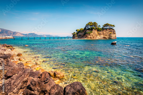 Sunny spring view of the Cameo Island. Picturesque morning scene in the Port Sostis, Zakinthos island, Greece, Europe. Beauty of nature concept background.