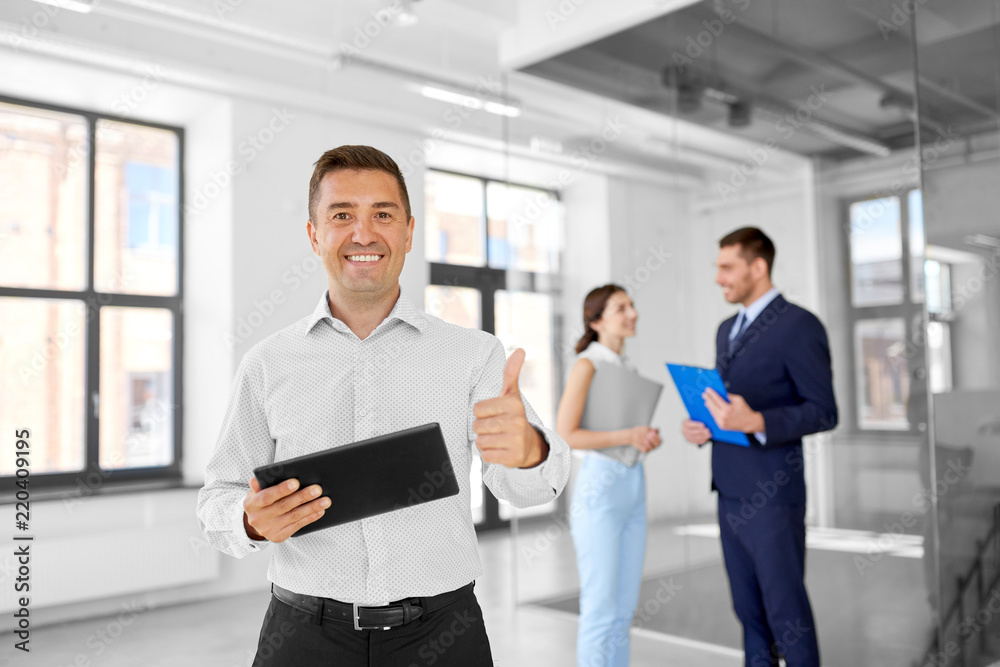 real estate business, sale and people concept - happy smiling realtor or businessman with tablet pc computer and customers at new office room real estate business, sale and people concept - happy smiling realtor or businessman with tablet pc computer and customers at new office room