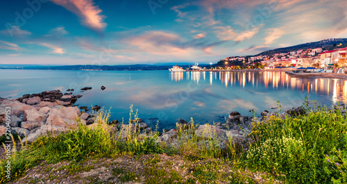 Great evening view of Pilos town. Colorful spring sunset on the Ionian Sea. Beautiful cityscape panorama of Greece city. Traveling concept background. Artistic style post processed photo.