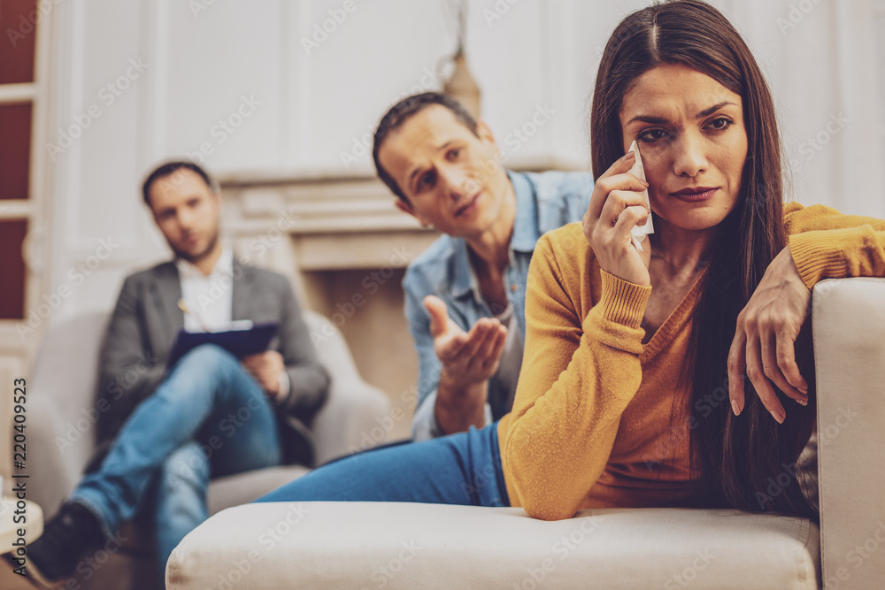 Want to talk with you. Worried male person wrinkling forehead while talking to his wife