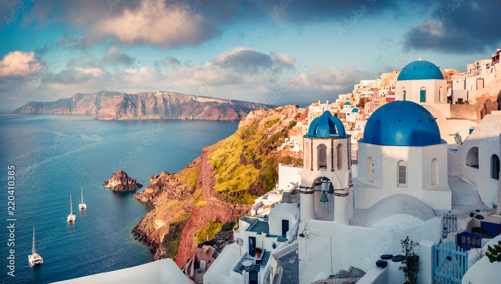 Sunny morning view of Santorini island. Picturesque spring sunrise on the famous Greek resort Oia, Greece, Europe. Traveling concept background. Artistic style post processed photo. - obrazy, fototapety, plakaty 