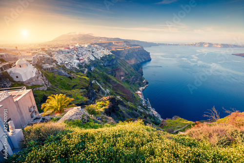 Sunny morning view of Santorini island. Picturesque spring sunrise on the famous Greek resort Thira, Greece, Europe. Traveling concept background.