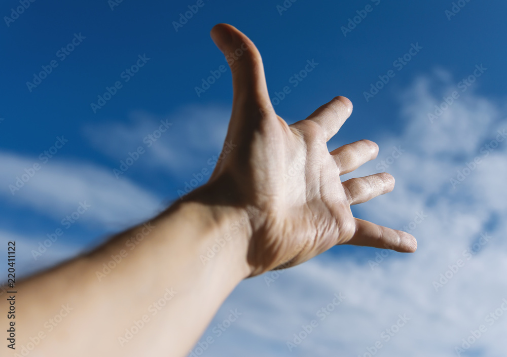 Hand of a man reaching to towards sky. Hand of a man reaching to towards sky.