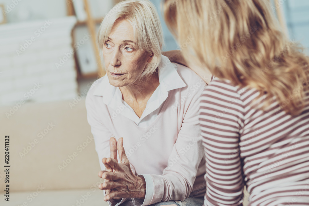 So nervous. Sad cheerless woman putting her hands together while being about her problems So nervous. Sad cheerless woman putting her hands together while being about her problems