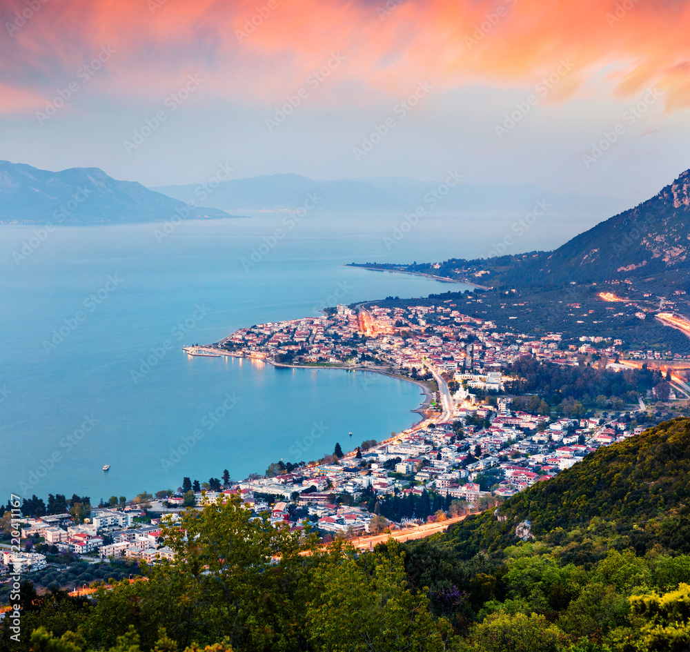 View from the bird's-eye of Kamena Vourla town in the evening mist. Colorful spring cityscape in Greece, Europe. Beautiful sunset on Aegean Sea. Artistic style post processed photo.