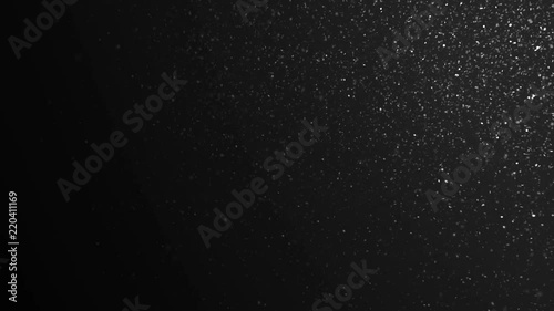 Snowflakes Floating on Black Background in Slow Motion. Looped 3d Animation of Dynamic Wind Particles In The Air With Bokeh. 4k Ultra HD 3840x2160 photo