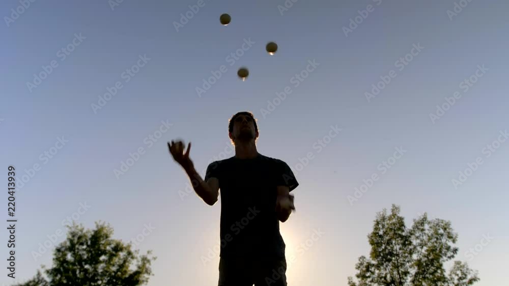 Man Juggling Five Balls at Sunset, Silhouette