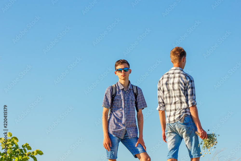 two young guys against the sky, a relationship with each other two young guys against the sky, a relationship with each other