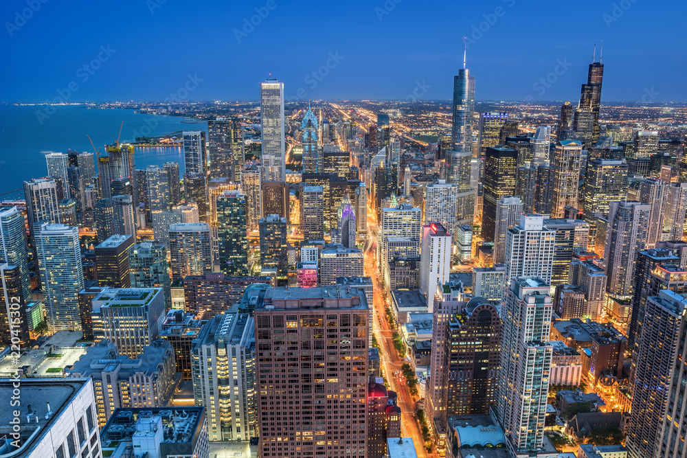 Fototapeta premium Chicago skyline with modern skyscrapers and the city lights taken at the blue hour, Illinois, United States