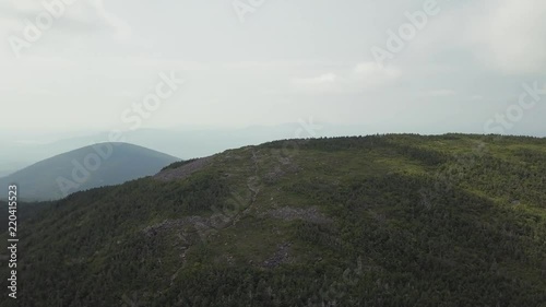 Aerial footage of White Cap Mountain situated within the watershed of the Pleasant River located in Piscataquis County, Maine. It has a distinguished treeline and remains snow covered into summer. photo