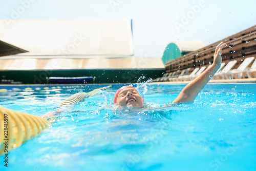 The portrait of happy smiling beautiful teen girl at the swimming pool. Little child at blue wate. Pool  leisure  swimming  summer  recreation  healthy lifstyle concept