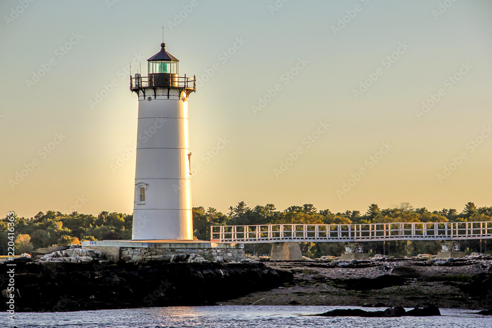 lighthouse by the sea at sunset