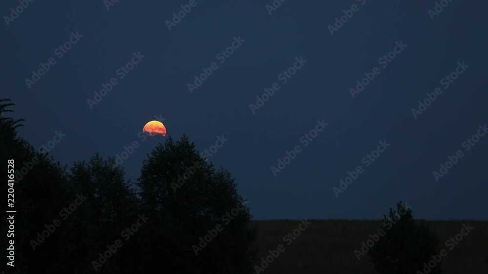 The moon in the evening sky. The clouds are floating on the moon. moon rise The moon in the evening sky. The clouds are floating on the moon. moon rise