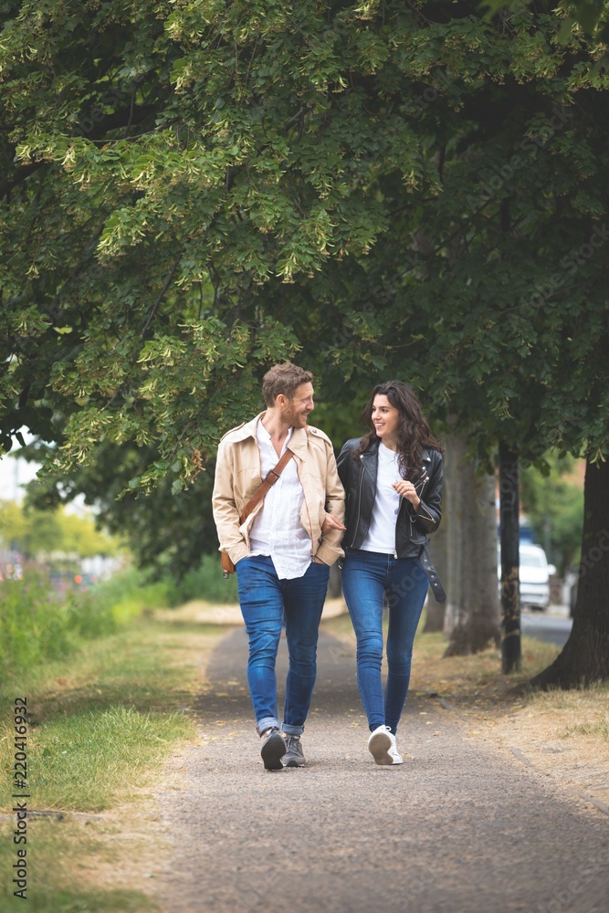Couple interacting while walking in street Couple interacting while walking in street