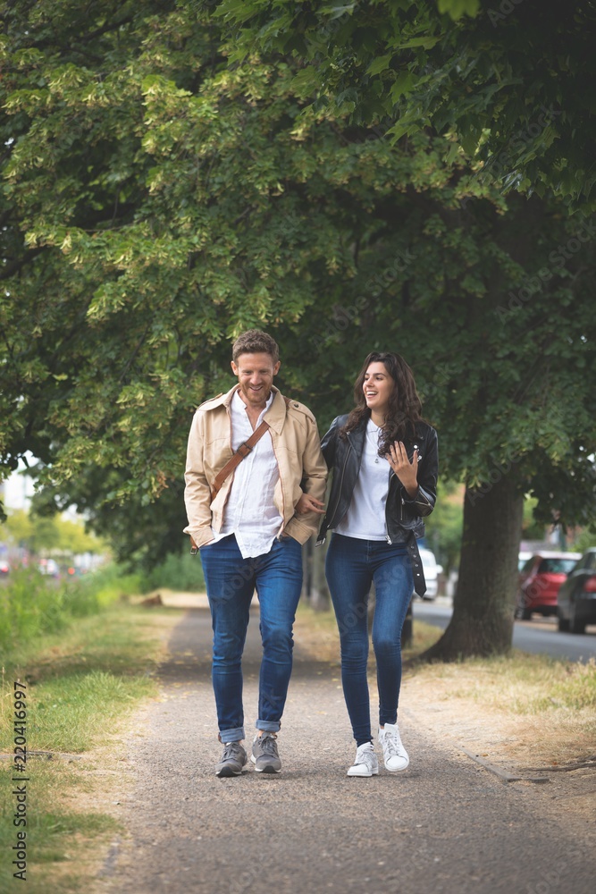 Couple interacting while walking in street Couple interacting while walking in street