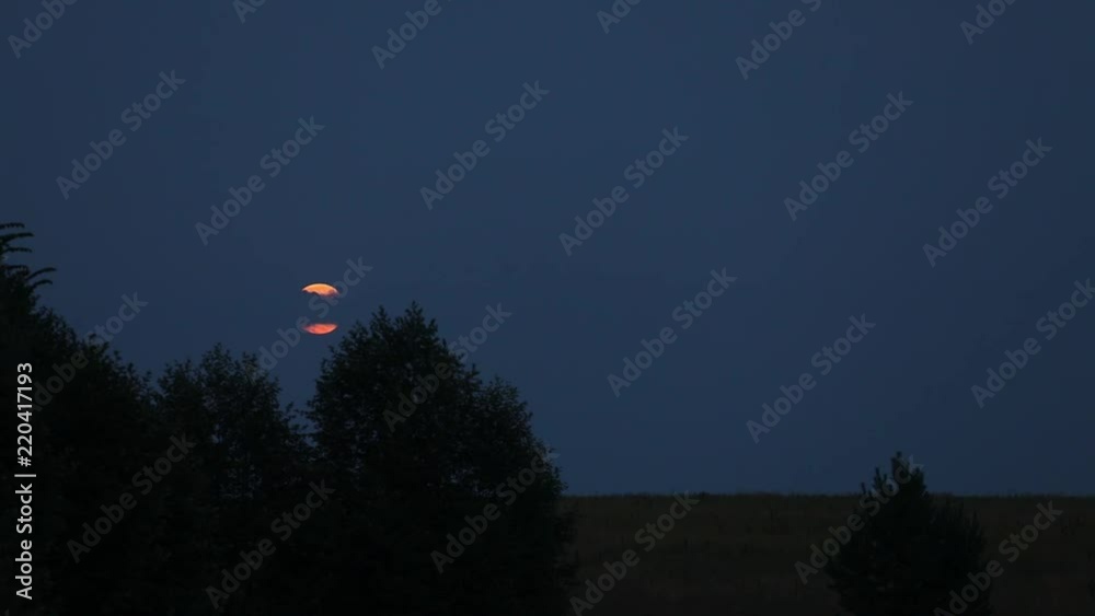 The moon in the evening sky. The clouds are floating on the moon. moon rise The moon in the evening sky. The clouds are floating on the moon. moon rise