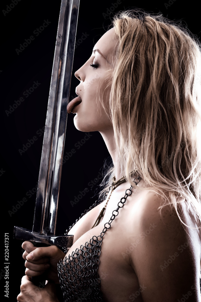 sexy warrior viking girl licks the blade of sword Stock Photo | Adobe Stock