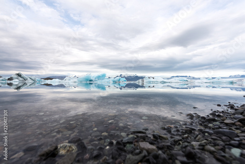 Jökulsárlón glacier lagoon with refelctions of a ice rock in the water an the glacier in the background of the jökulsarlon