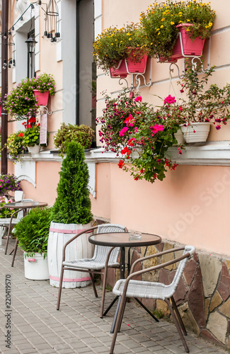 Store front of a flower shop with table and a chears selling garden plants © Anton
