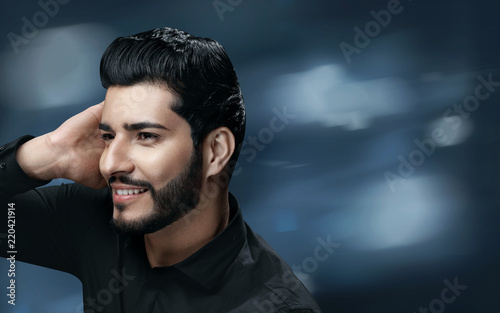 Men Hair Care. Handsome Man With Beard Touching Healthy Hair © puhhha