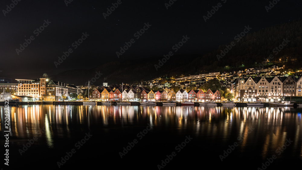 Bergen norway brygge by night with reflection in the water, norway, europe