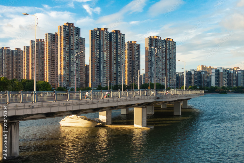 Obraz premium Daytime Upscale Apartments on River and Boating Area